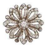 A late 19th century diamond brooch, of openwork stylised flowerhead design with central diamond