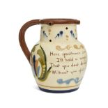 A Torquay motto puzzle jug, inscribed with the motto, Here Gentlemen come try your skill, I'll