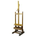 An oak artist's studio easel, mid 20th Century, of typical form, with adjustable rest and clamp,