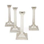 A set of four George III silver candlesticks, three London, c.1775, probably John Carter II, one