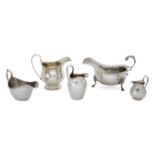 An assortment of five silver cream jugs, various dates and makers, including one raised on a