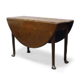 A George II mahogany oval drop leaf dining table, raised on cylindrical tapering legs to pad feet,