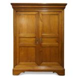 A French provincial fruitwood armoire, 19th Century, the moulded top above two panelled cupboard