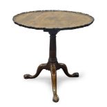 A George III mahogany tilt top occasional table, the circular pie crust top above tapering stop