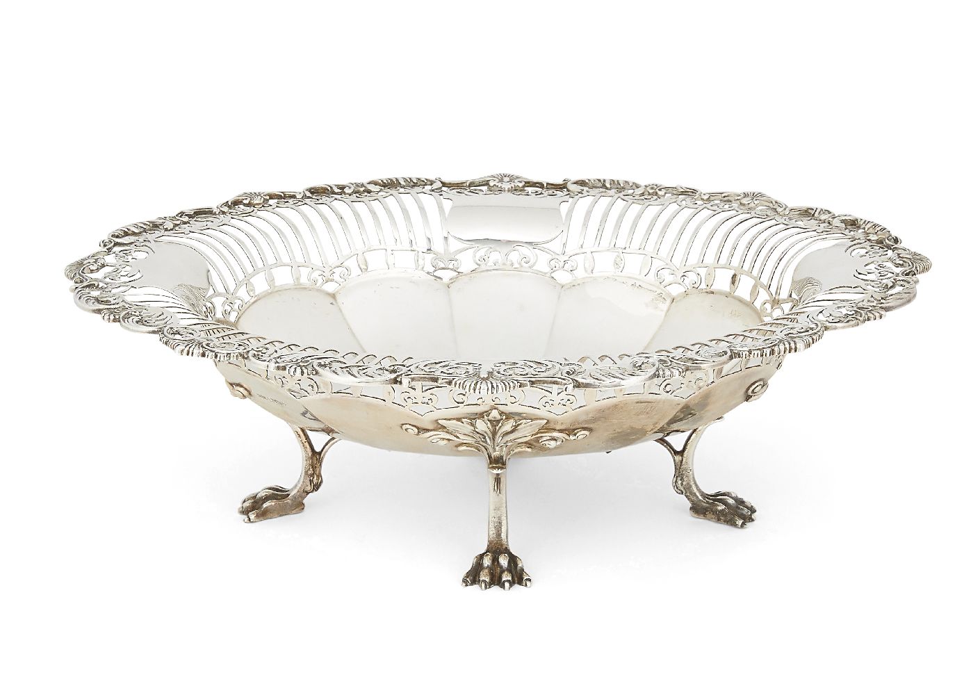 A pierced silver dish, Sheffield, c.1913, Mappin & Webb, raised on four lion paw feet, the perimeter