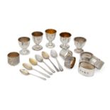 A quantity of silver eggcups and napkin rings, all in individual boxes, comprising: five silver