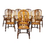 A matched set of ash and elm Windsor armchairs, 19th Century and later, the hooped backs, with