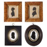 A pair of silhouette portraits of a husband and wife, 19th century, in matching maple veneered
