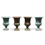 A set of four Victorian cast iron campana urns, 57cm high (4)Please refer to department for