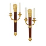 A pair of French Empire style wall lights, 20th century, the backplates formed as Neoclassical arrow