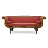 A Regency mahogany sofa, the top rail with raised gadrooning, having carved scrolling arms,