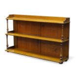 A set of Victorian shelves, having three graduated tiers, with turned baluster supports, raised on