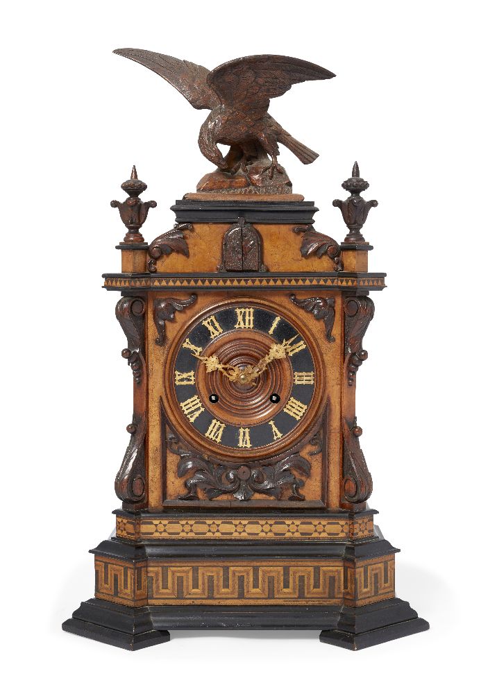 A Black Forest walnut, parquetry and ebonised wood cuckoo clock, 19th century, the top mounted