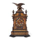 A Black Forest walnut, parquetry and ebonised wood cuckoo clock, 19th century, the top mounted