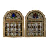 A set of three arched stained glass windows, 18th/19th Century, with foliate design above an