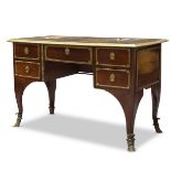 A Régence mahogany desk, early 18th Century, the leather covered top with polished brass edge, the