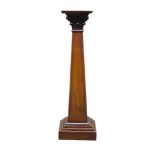 A carved mahogany plinth, early 20th Century, the square top above carved Corinthian capital, on