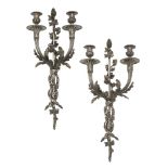 A pair of French Louis XVI style silvered metal two branch wall lights, late 19th/early 20th