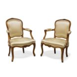 A pair of Louis XV beech fauteuils by Jean Boucault, mid 18th Century, one chair stamped 'Boucault',