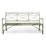 A Regency white painted cast iron garden bench, with shaped openwork back and slat seat, having