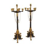 A pair of bronze and gilt bronze table lamps, in the style of Empire five light candelabra, late