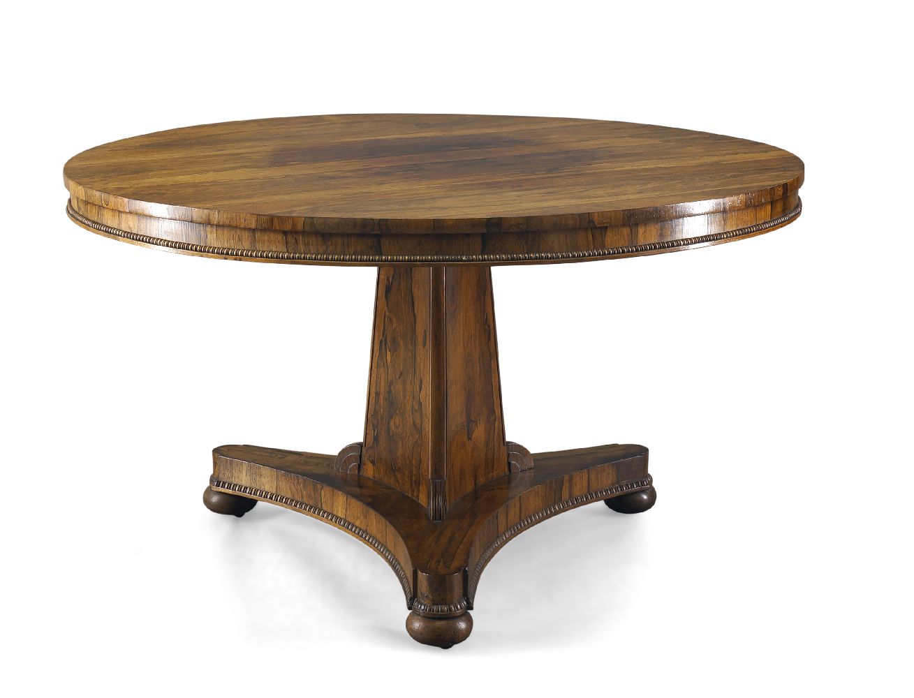 A Regency rosewood tilt top centre table, the circular top with bead moulded edge, on tri-form