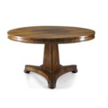 A Regency rosewood tilt top centre table, the circular top with bead moulded edge, on tri-form