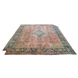 An Ushak carpet, early 20th Century, the medallion in faded brick field with stepped green