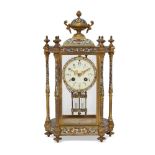 A French champlevé and brass mantel clock, 20th century, mounted with an urn finial, the glazed