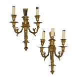 A pair of French three branch wall lights, in the Louis XVI taste, 19th century, the backplates