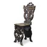 An Italian carved walnut Sgabello chair, late 19th Century, the pierced back with carved caryatids