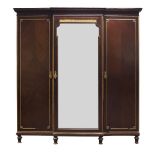 A mahogany and parcel gilt breakfront triple wardrobe, early 20th Century, the moulded cornice above