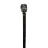 An ebony walking cane, late 19th/early 20th century, the finial in the form of an African man's