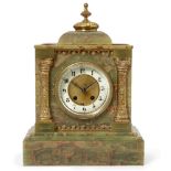 A late Victorian onyx mantel clock, the case of architectural design with a brass domed finial to