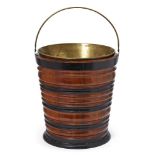 A Dutch walnut and ebonised wood peat bucket, 19th century, with a brass liner, 32cm highPlease