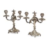 A pair of Continental silvered brass candelabra, late 19th/early 20th century, the bases pierced