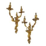 A pair of French gilt bronze twin light wall lights, 20th century, with a scrolling and foliate