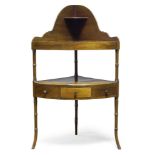 A Victorian mahogany corner washstand, the curved top shelf with shaped splash back, over