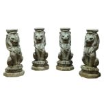 A set of four re-constituted stone seated lions, 20th century, together with a pair of re-