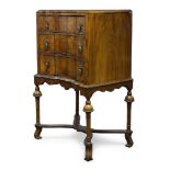 A William and Mary style walnut cabinet on stand, early 20th Century, with recessed serpentine