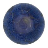 A cobalt-blue glazed bowl, Iran, late 12th-early 13th century, of conical form on a short foot,