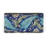 A Damascus Iznik border tile, late 16th century, of rectangular form, the cobalt-blue ground with