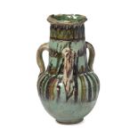 A Fatimid Fayyoum ware glazed pottery handled jar, Egypt, 11th century, rising from short foot