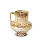 A small intact Kashan lustre-glazed jug with inscriptions, Iran, late 12th century, on a short