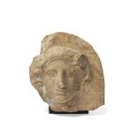 A Greek terracotta antefix with the head of Io, Taranto, circa 4th Century B.C., the nymph