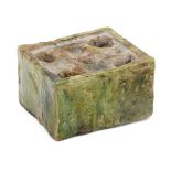 A glazed pottery inkwell, Central Asia 12th-13th century, of rectangular form with five circular