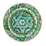 An Iznik pottery plate, Turkey, 17th century, with wide sloping rim and slightly raised well,