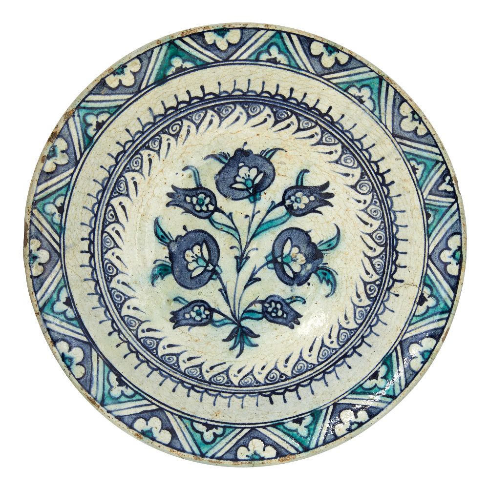 A large Iznik pottery dish with three large blue flowers, Ottoman Turkey, late 16th-early 17th