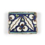 A Damascus Iznik border tile, 16th century, of rectangular form, the cobalt-blue ground decorated