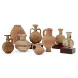 A group of pottery vessels including a Cypro-Mycenaean vessel with squat globular body and loop